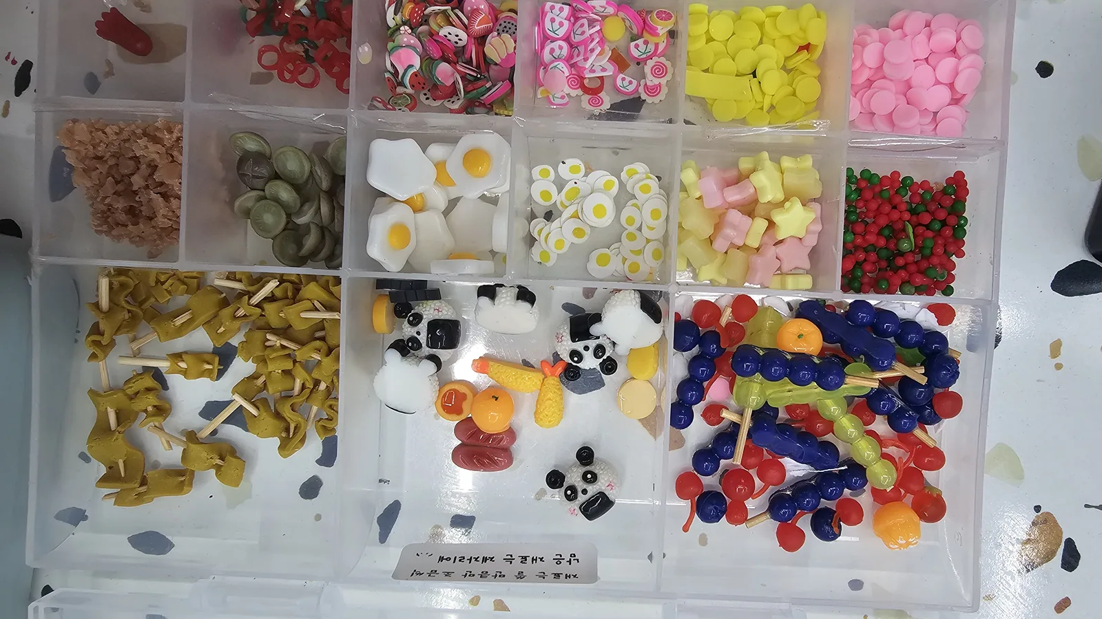 Full front view of multiple miniature food ingredient boxes at Amado Leather Workshop, organized by ingredient type