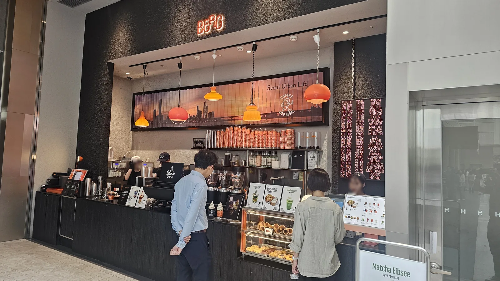 BERG cafe storefront inside The Hyundai Seoul with orange lighting Seoul Urban Life signage and queue of customers