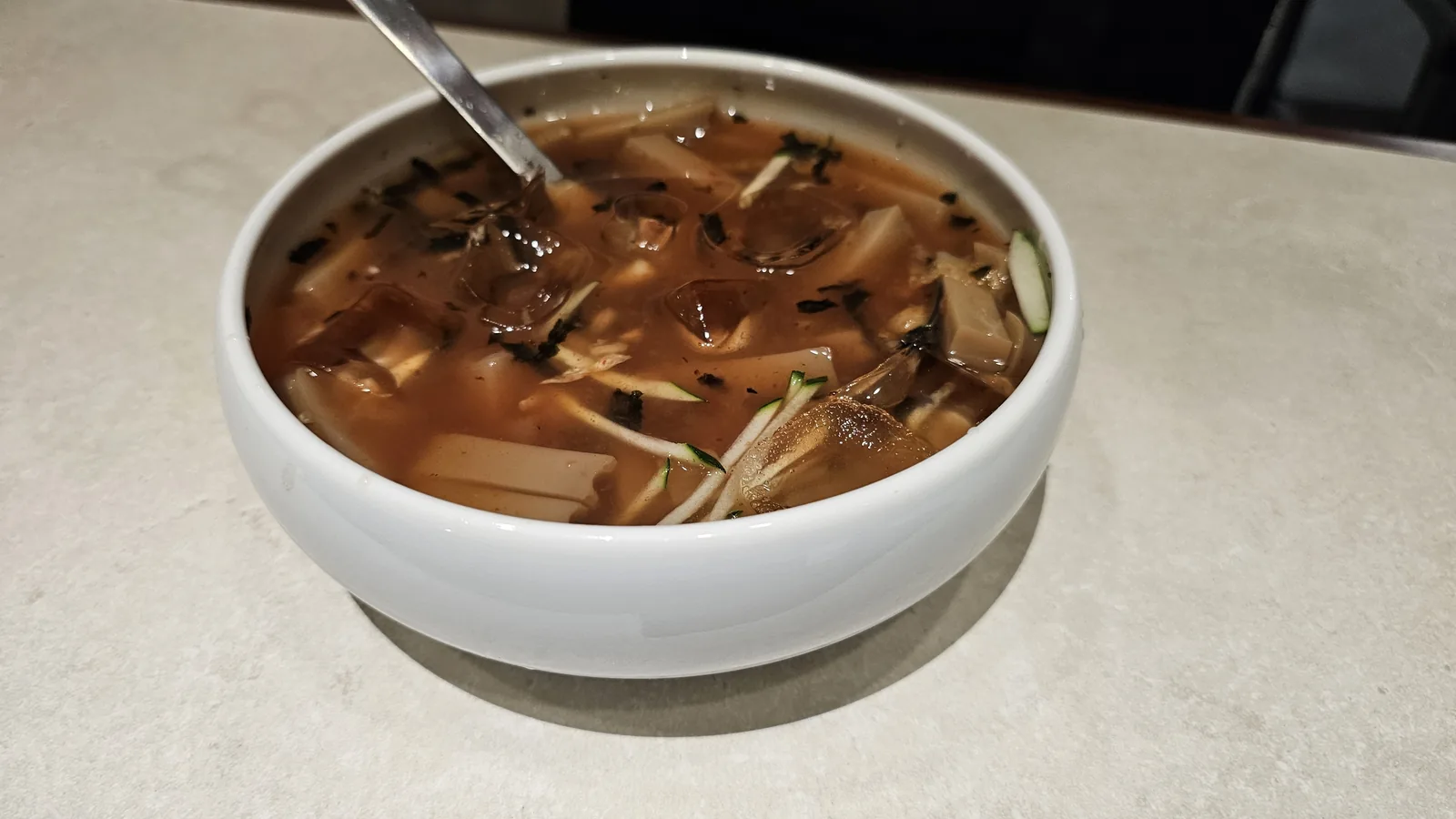 Chilled acorn jelly and cucumber soup, dotorimuk oi naengguk, served with a ladle at Daedong Jangeo Yeouido