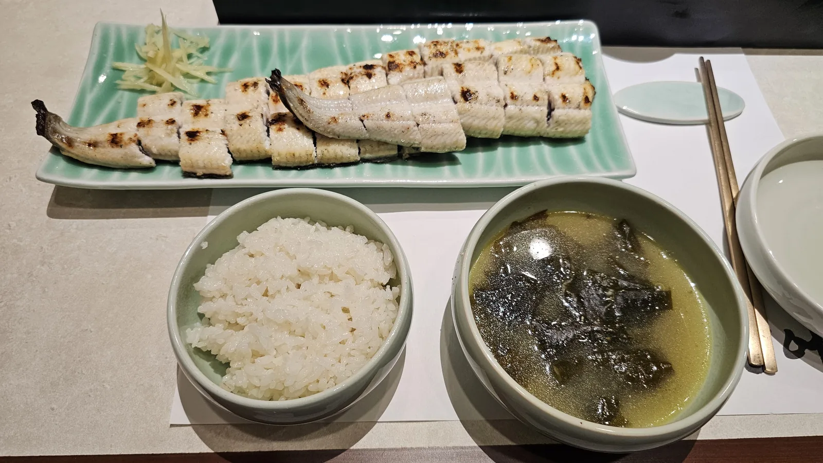 Full grilled eel set meal spread at Daedong Jangeo — eel, rice, seaweed soup, and side dishes