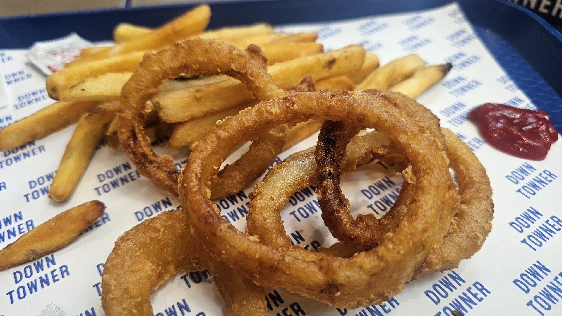 Onion rings and original fries close-up with ketchup dipping sauce at Downtowner Yeouido