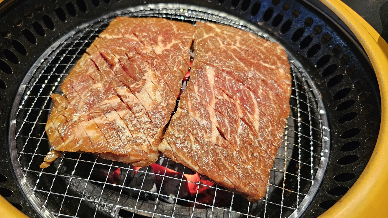 King beef short ribs grilling over charcoal at Galbidorak, mid-cook stage