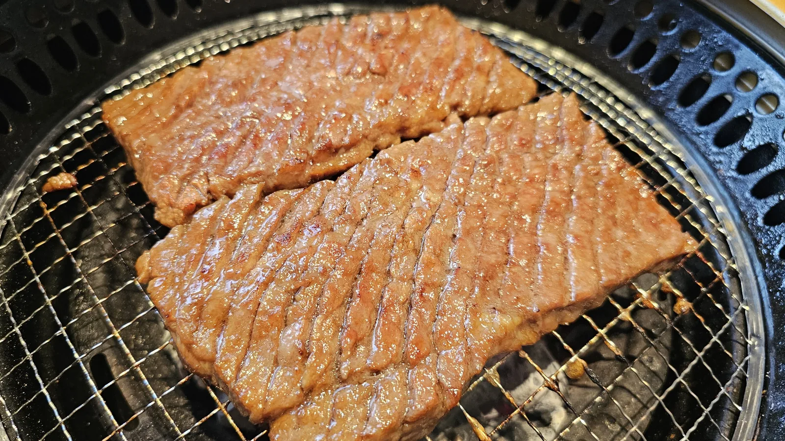 Marinated beef galbi nicely browned and glazed over charcoal grill at Galbidorak