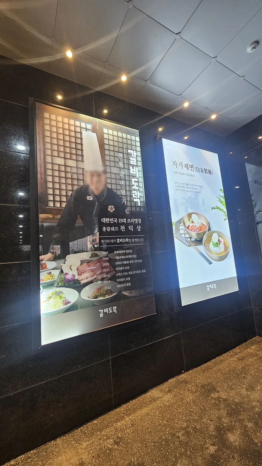 Galbidorak restaurant entrance at night — signage for house-made cold noodles and Master Chef credentials
