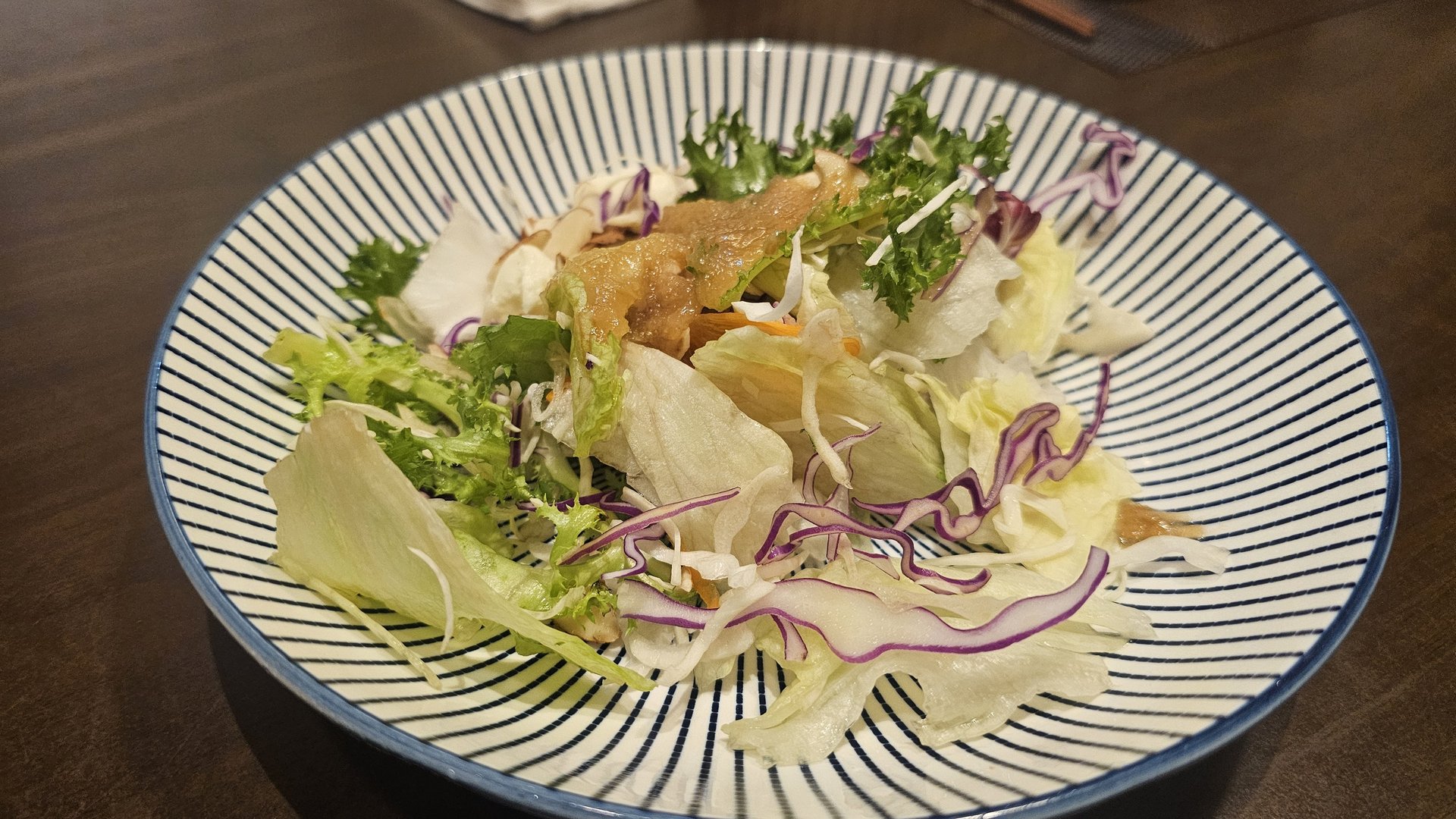 Mixed green salad with shredded red cabbage and dressing at Ginza Yeouido