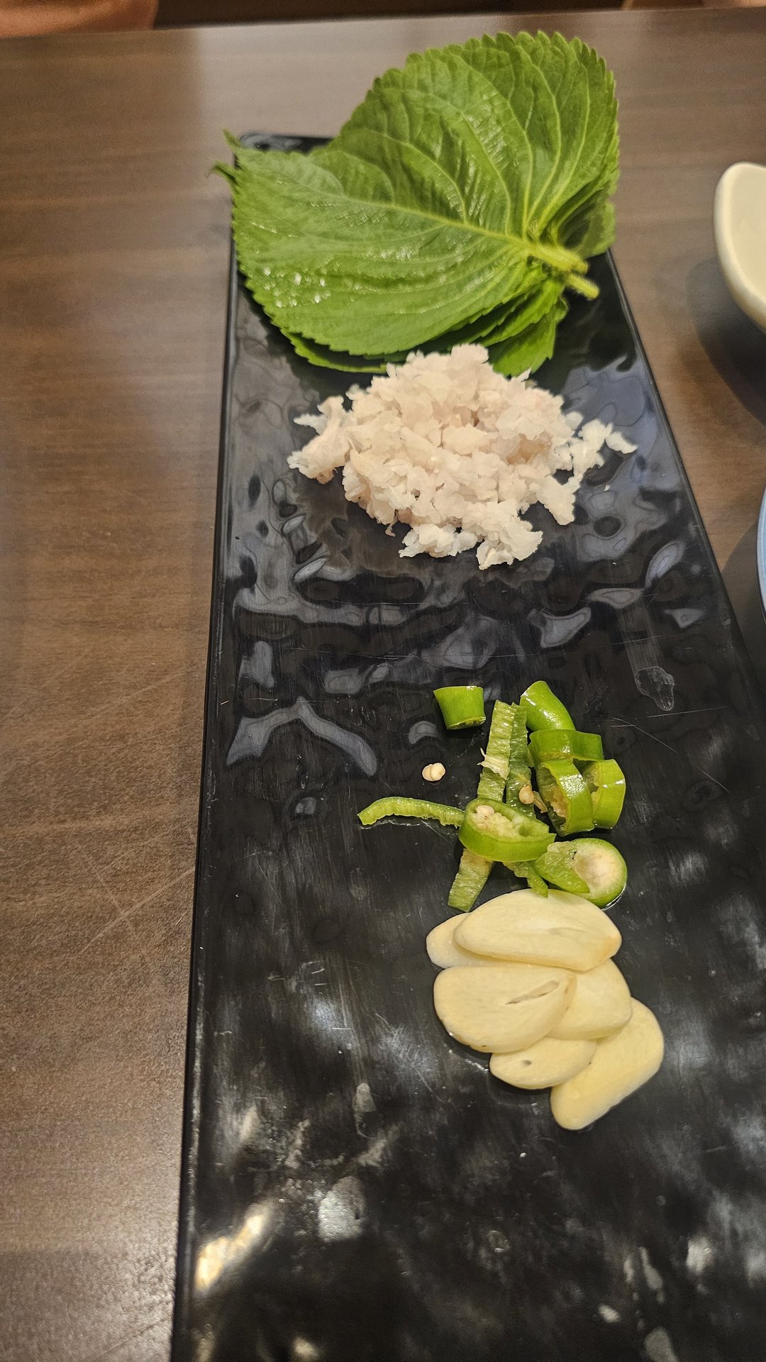 Ssam wrapping tray with perilla leaves and condiments from alternate angle at Ginza Yeouido