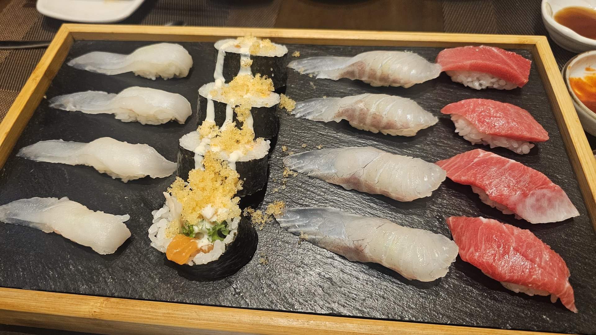 Assorted sushi on slate board including flounder, otoro tuna, and gunkan rolls at Ginza Yeouido