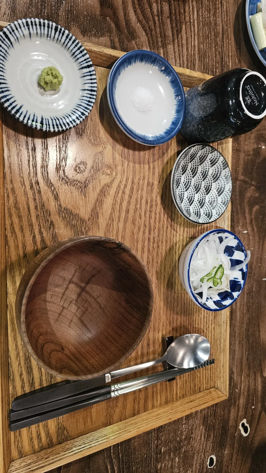 GU.I Yeouido table setting flat lay with wasabi, salt, pickled onion, empty rice bowl, and chopsticks