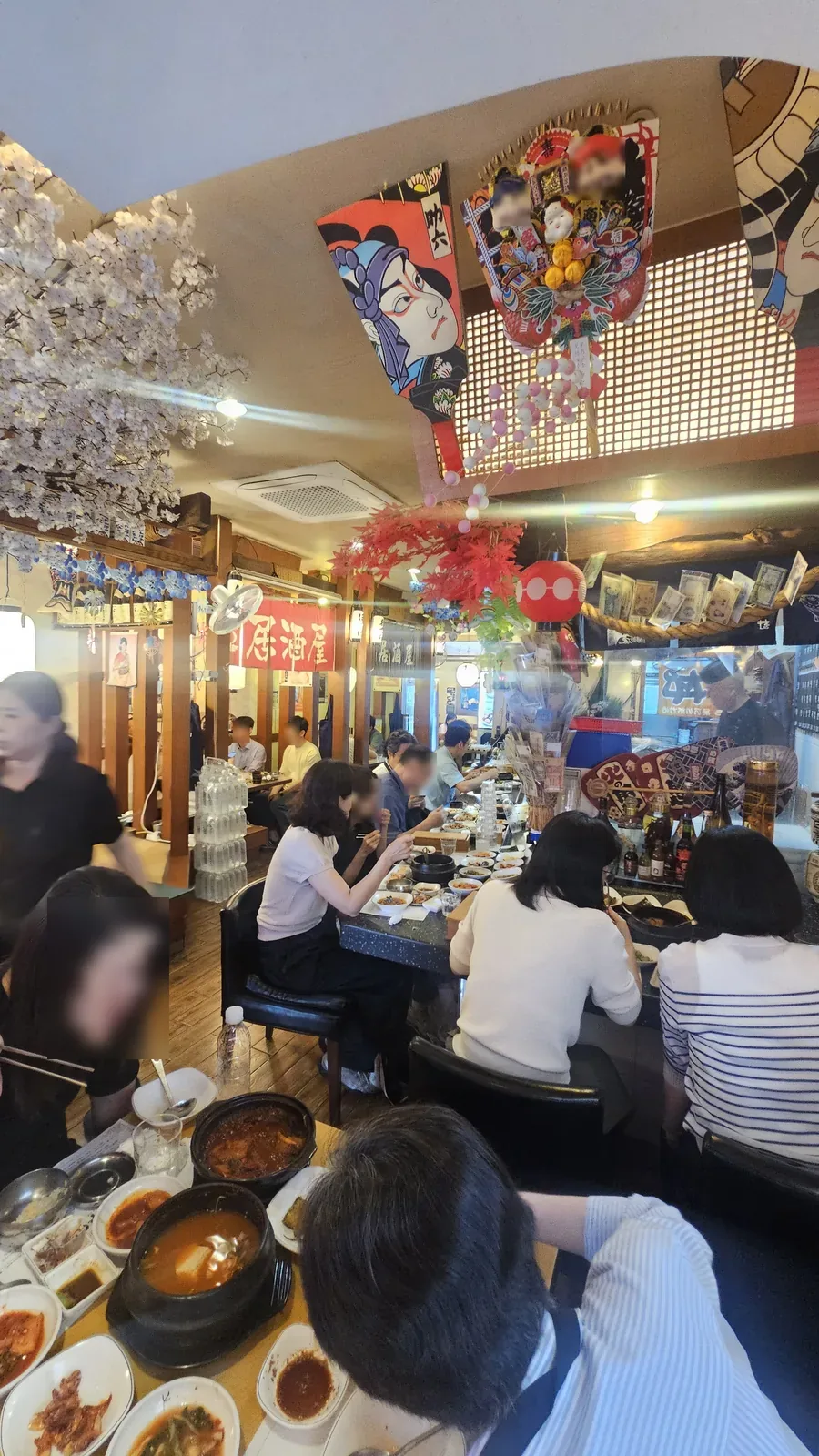 Busy lunch crowd inside Guigui Yeouido with izakaya-style interior decor fully packed