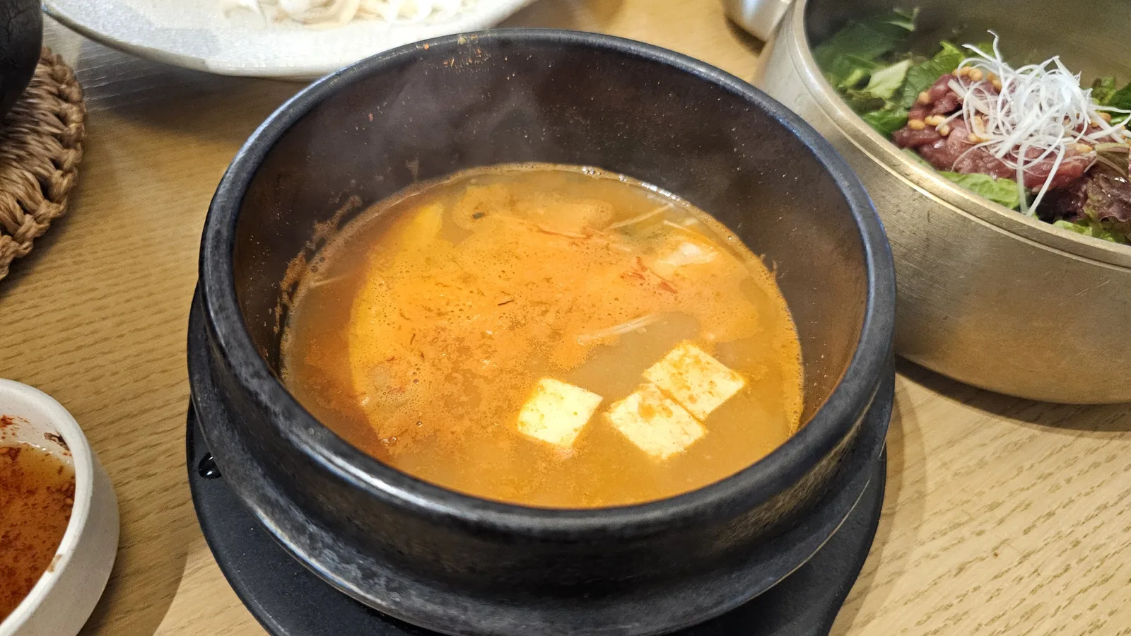 1++ Hanwoo cheonggukjang bubbling in black earthenware pot with tofu at Hanam-dong Yeouido