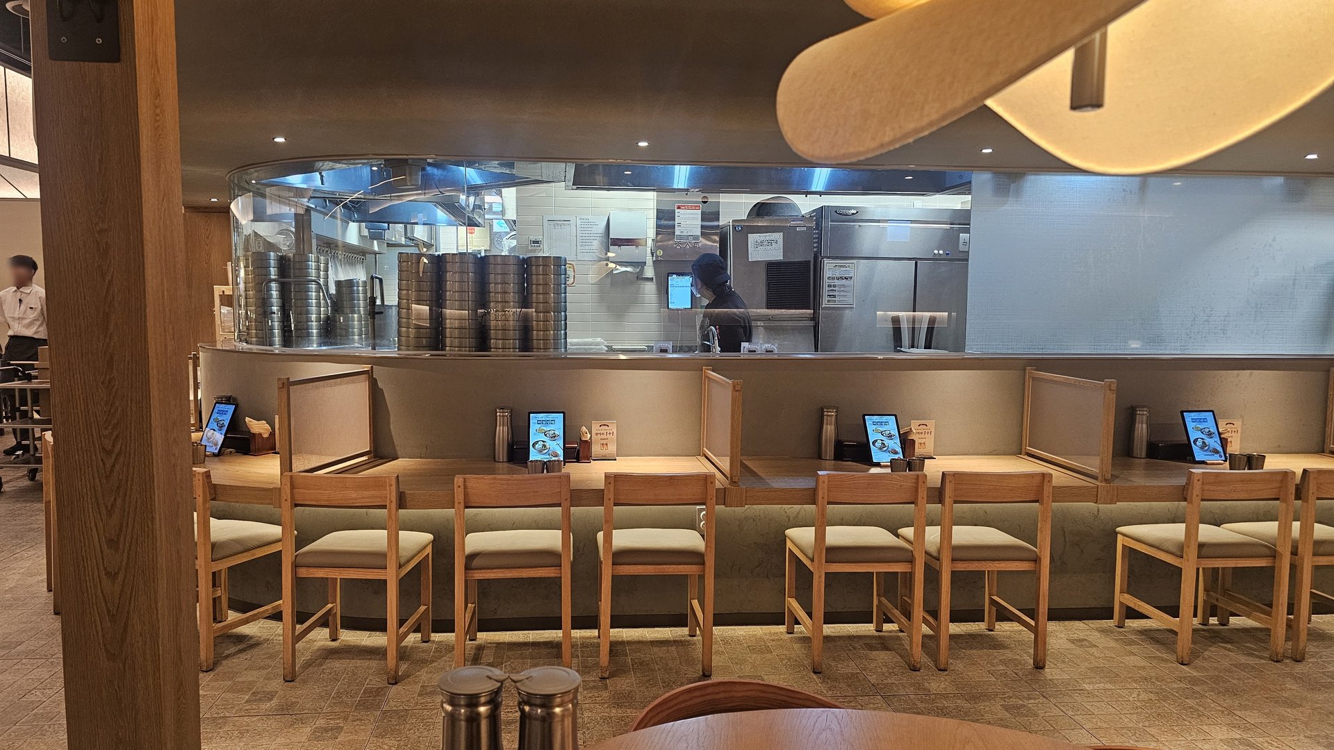 Open kitchen counter with single-seat bar stools at Jeil Myeonso Yeouido IFC