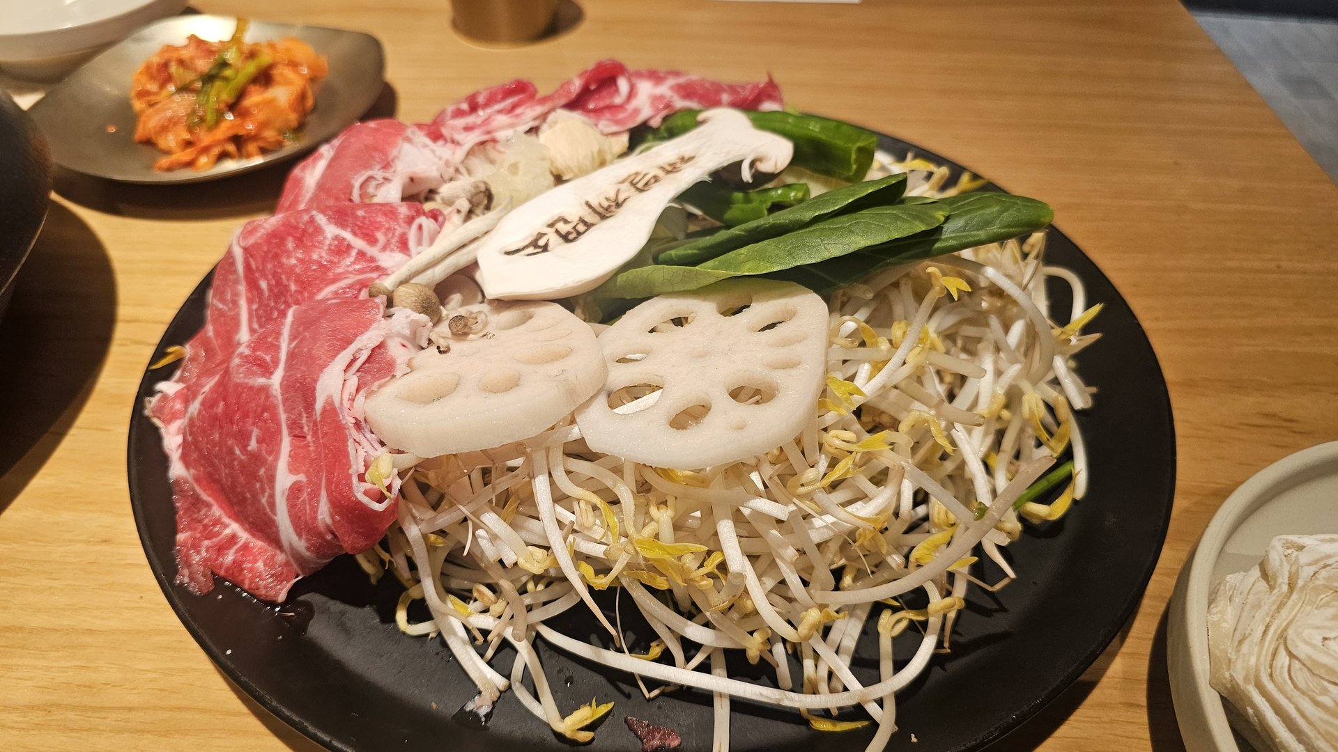 Jeil Myeonso shabu shabu hot pot boiling with cooked meat and vegetables, broth turning rich and cloudy