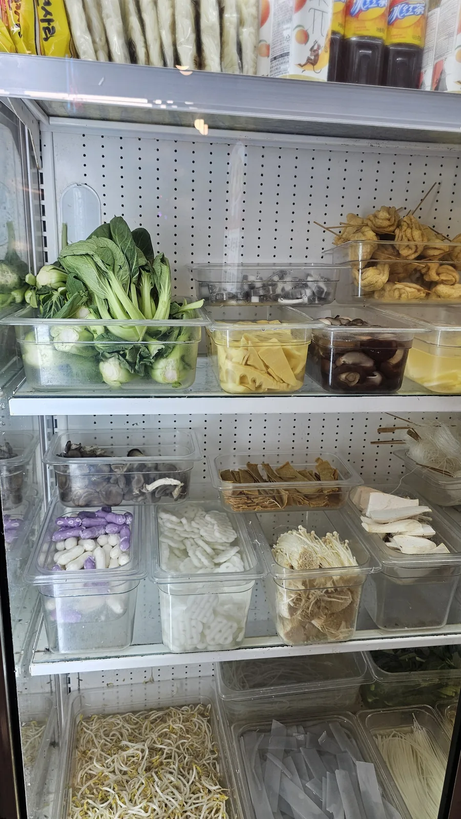 Malatang self-pick refrigerator with bok choy, bamboo shoots, mushrooms, tofu skin, and meatballs at Miyeon Cheongyang
