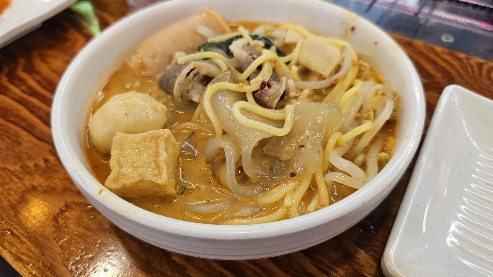 Finished malatang bowl with noodles, fish cake, tofu, mushrooms, and bean sprouts at Miyeon Cheongyang