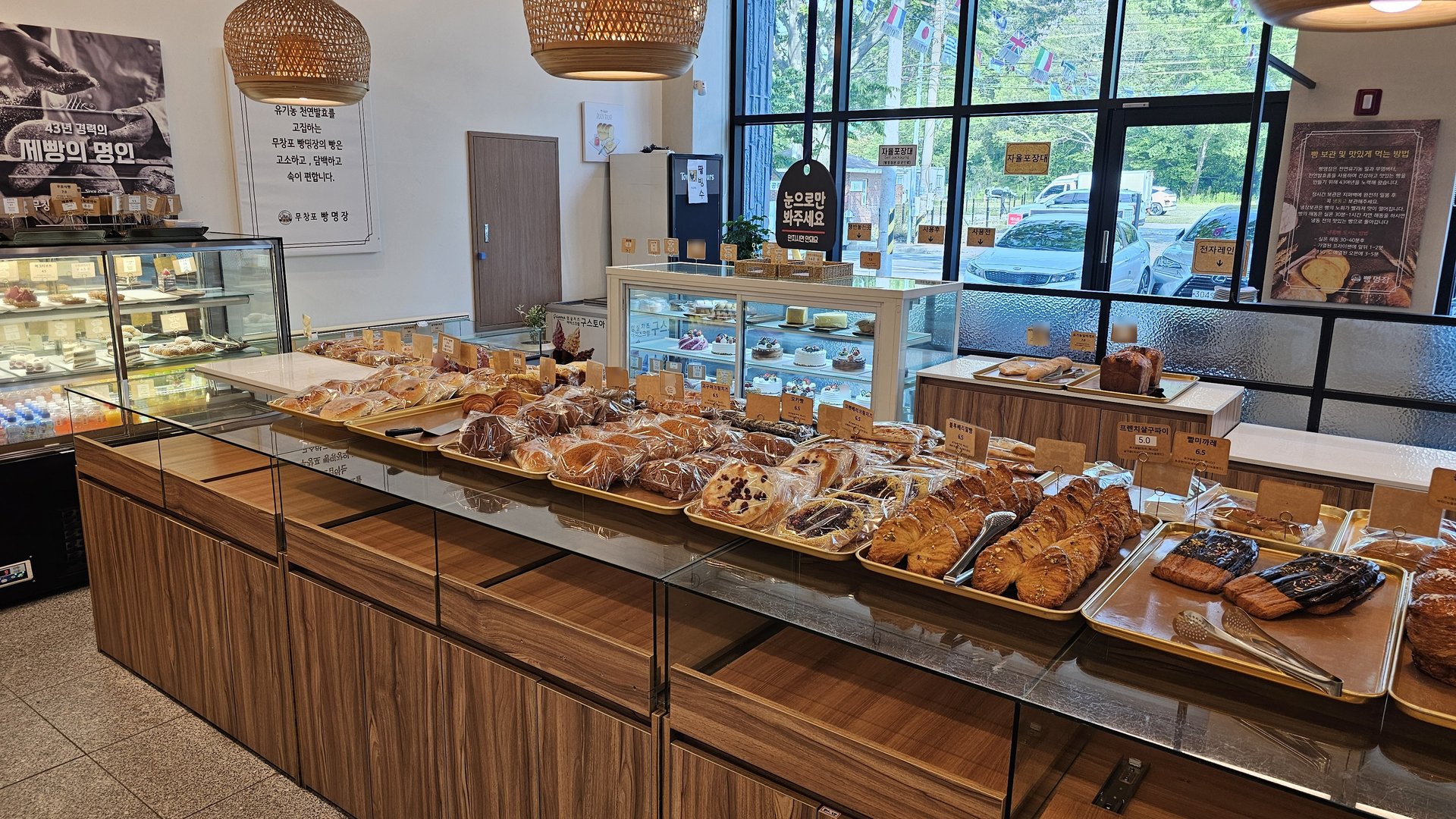 Wide main bread display counter at Mochang-po Bread Cafe with baguettes, loaves, and salt bread