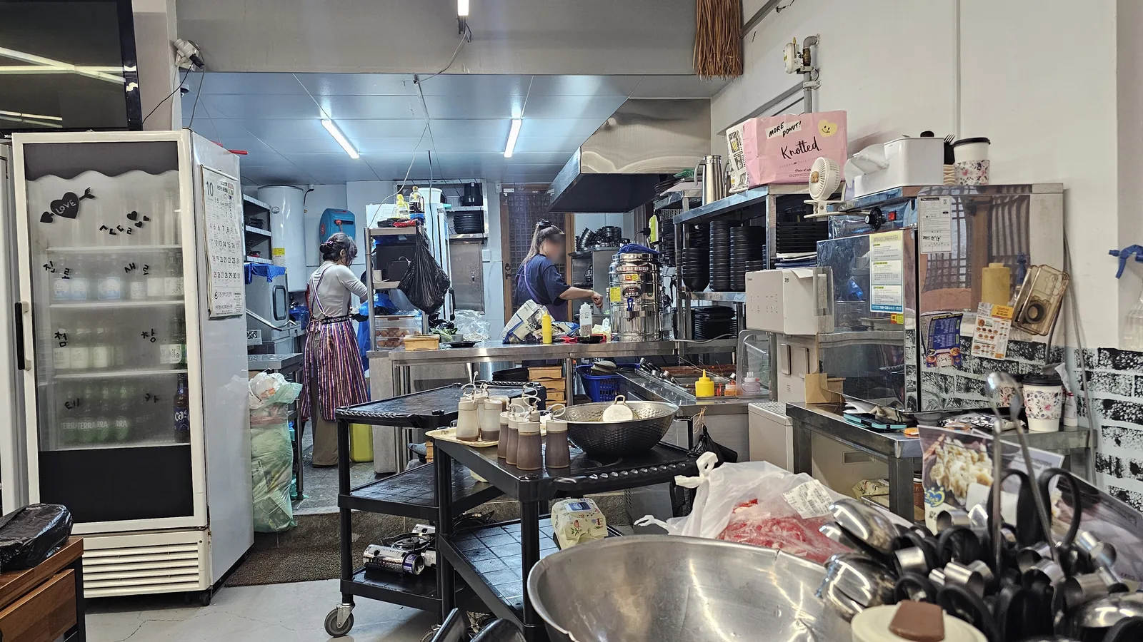 Kitchen staff preparing galbi dishes in the open kitchen at Sejong Daewang Hangari Jeonju