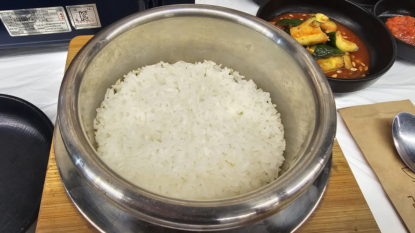 Sotbap rice pot opened showing fully cooked white rice inside the metal pot