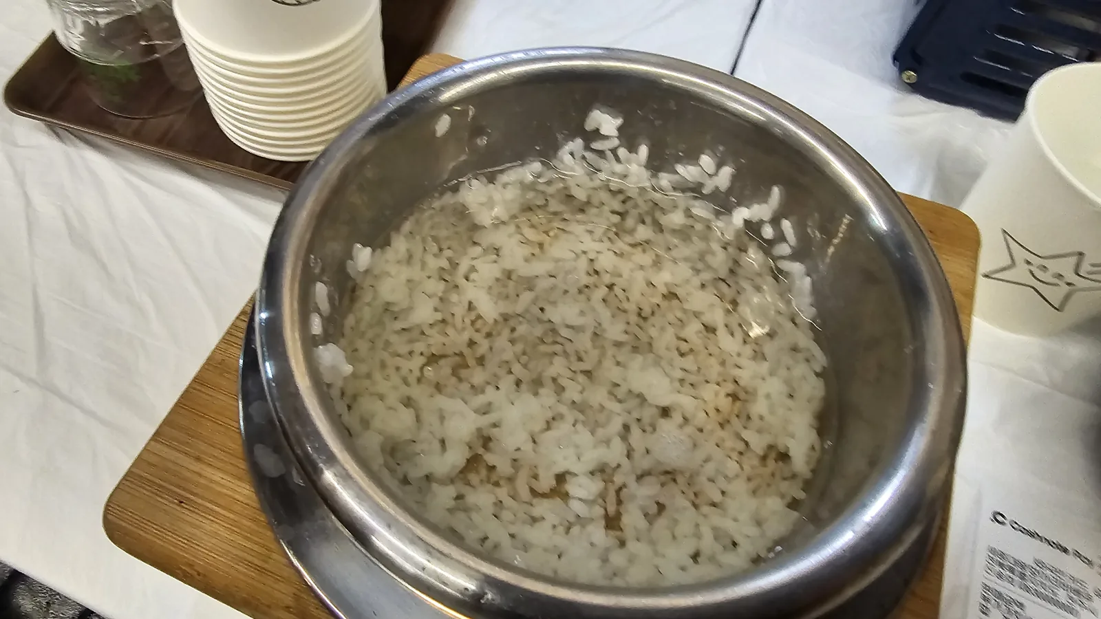 Nurungji scorched rice in sotbap pot with water added to begin making rice tea