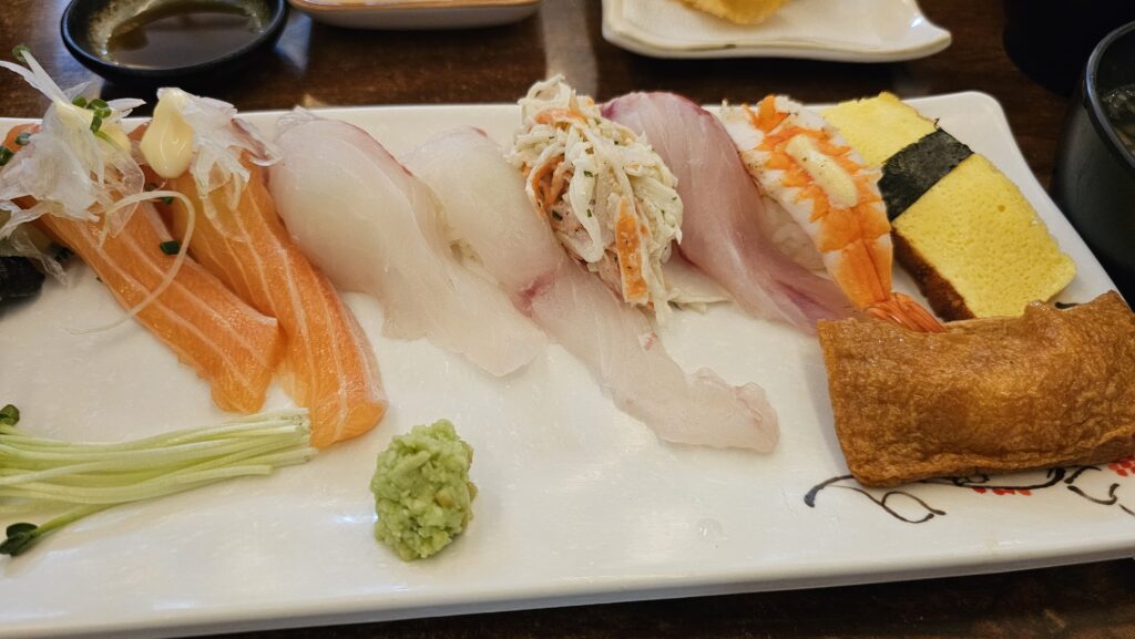 Close-up of Lunch Set A 10-piece sushi at Shinhee Sushi Yeouido with wasabi and microgreens
