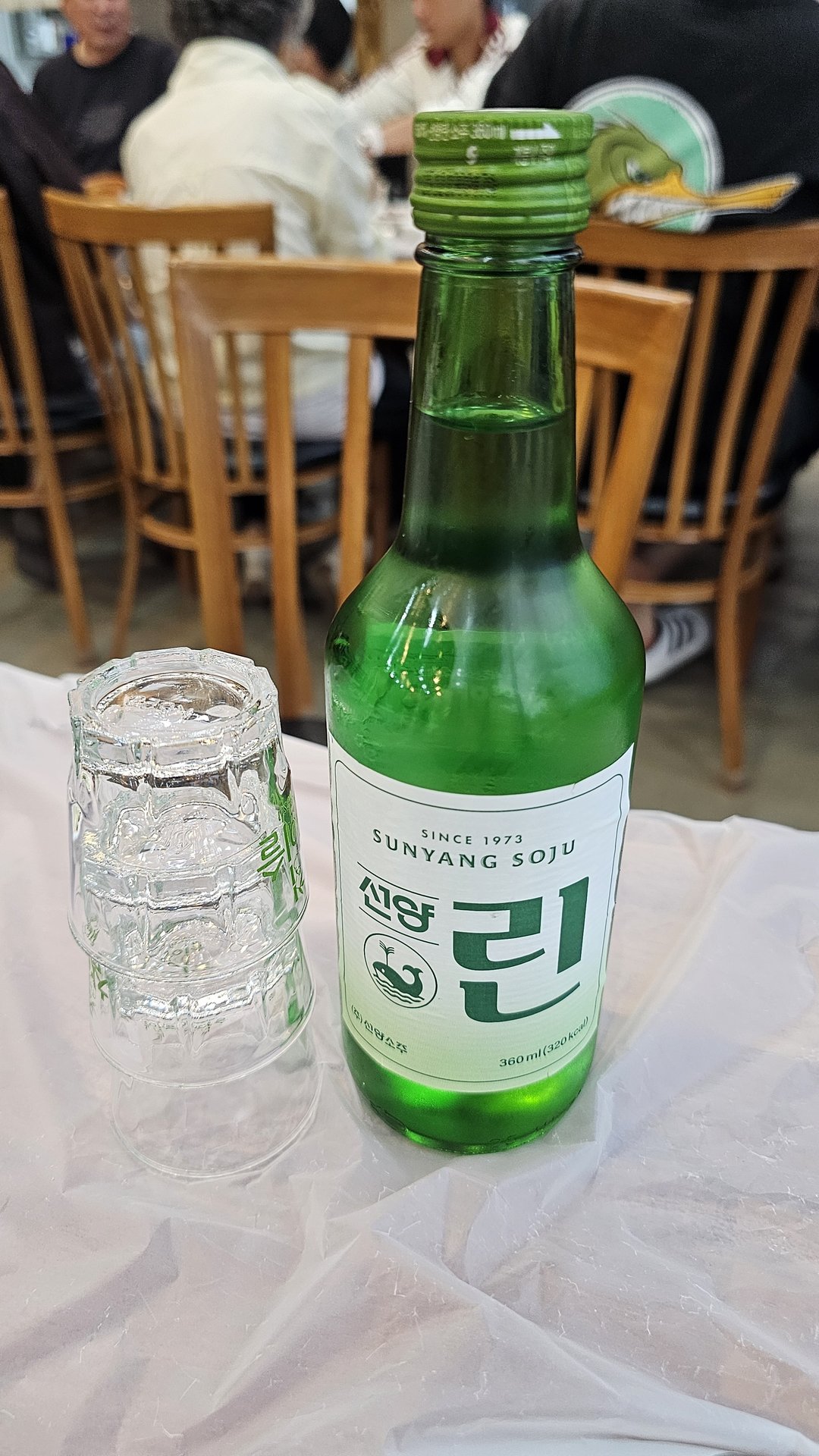 Seonyang soju bottle and shot glasses on the table at Songnim Cheongyang