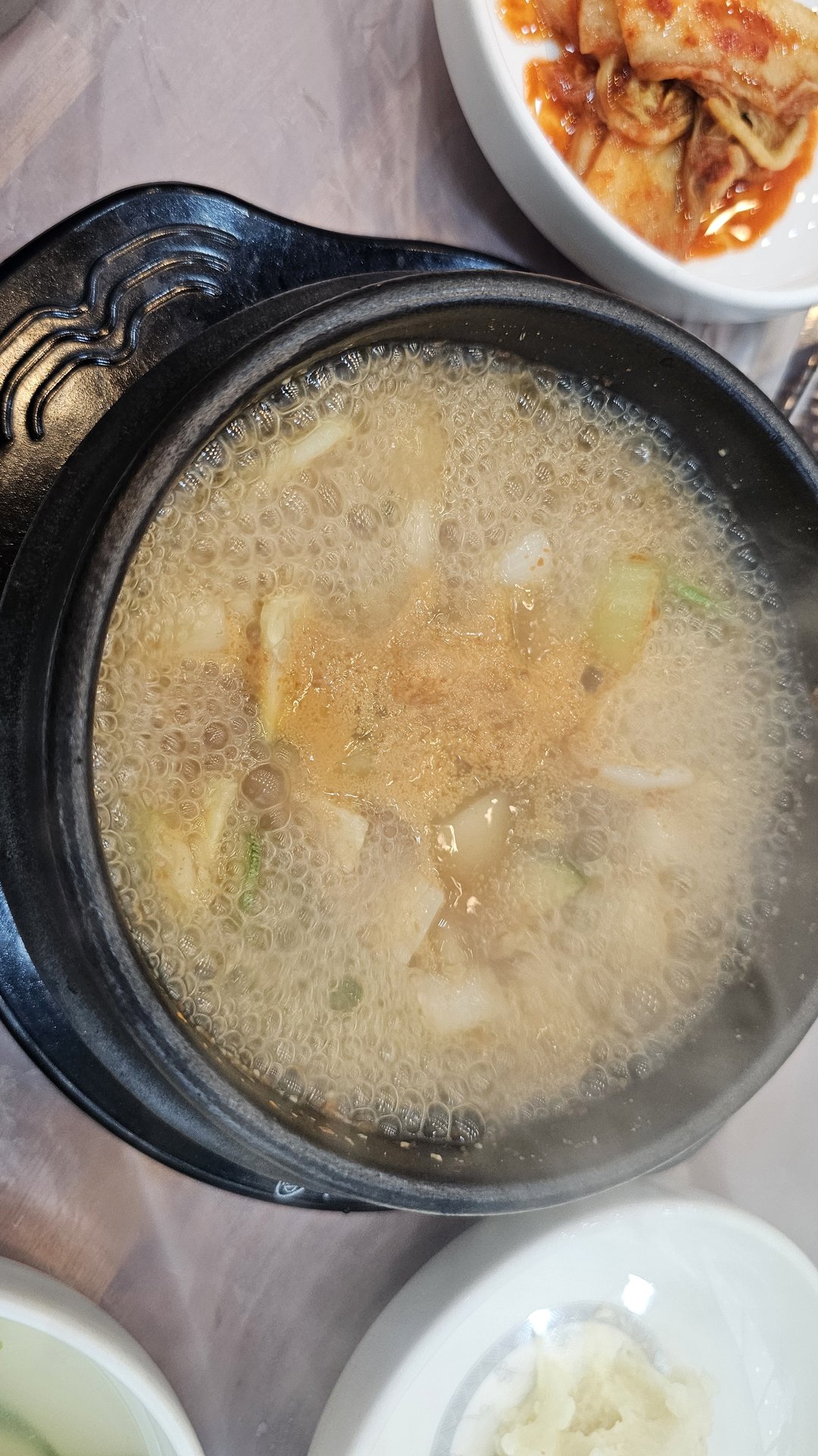 Steaming doenjang soup in a stone pot (ttukbaegi) at Songnim Cheongyang, served with kkakdugi and rice