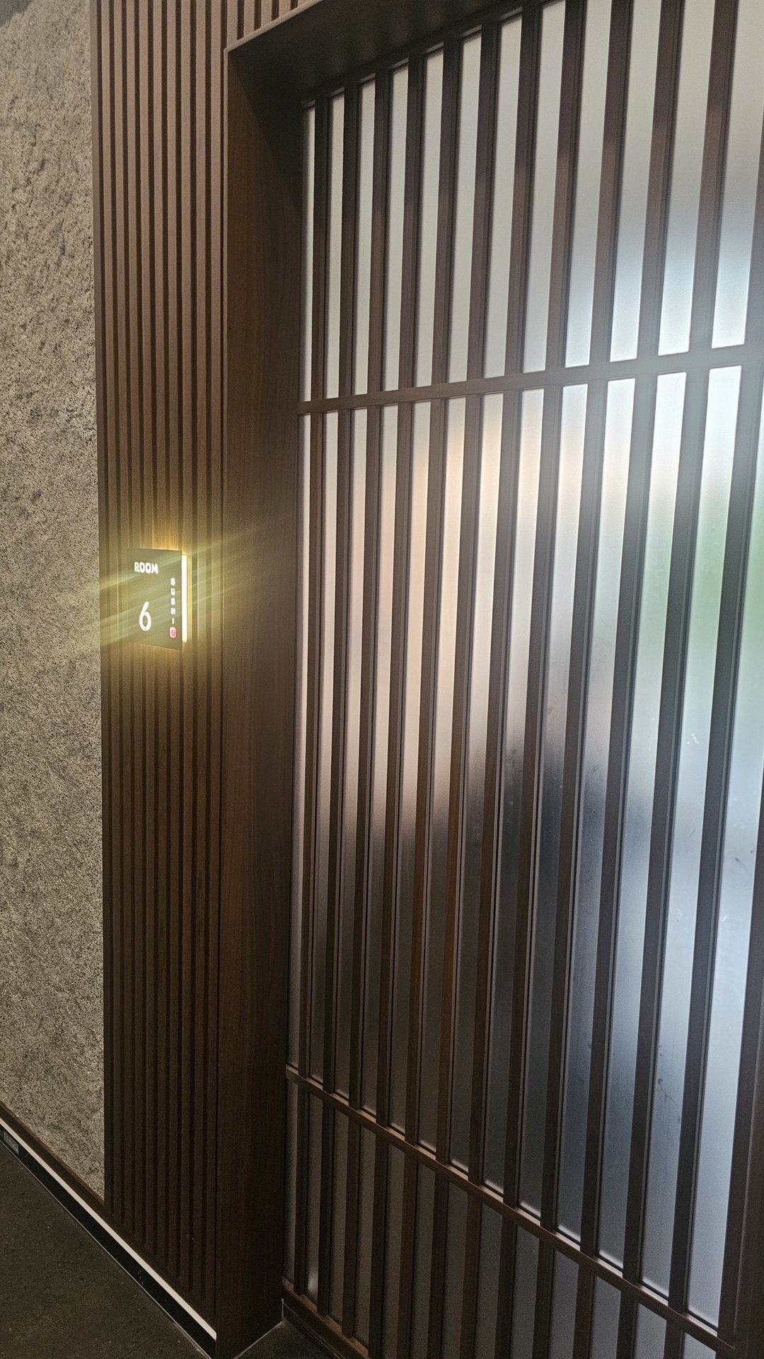 Sushi Yu restaurant entrance with dark wood louver panel exterior at Brighton Square Yeouido