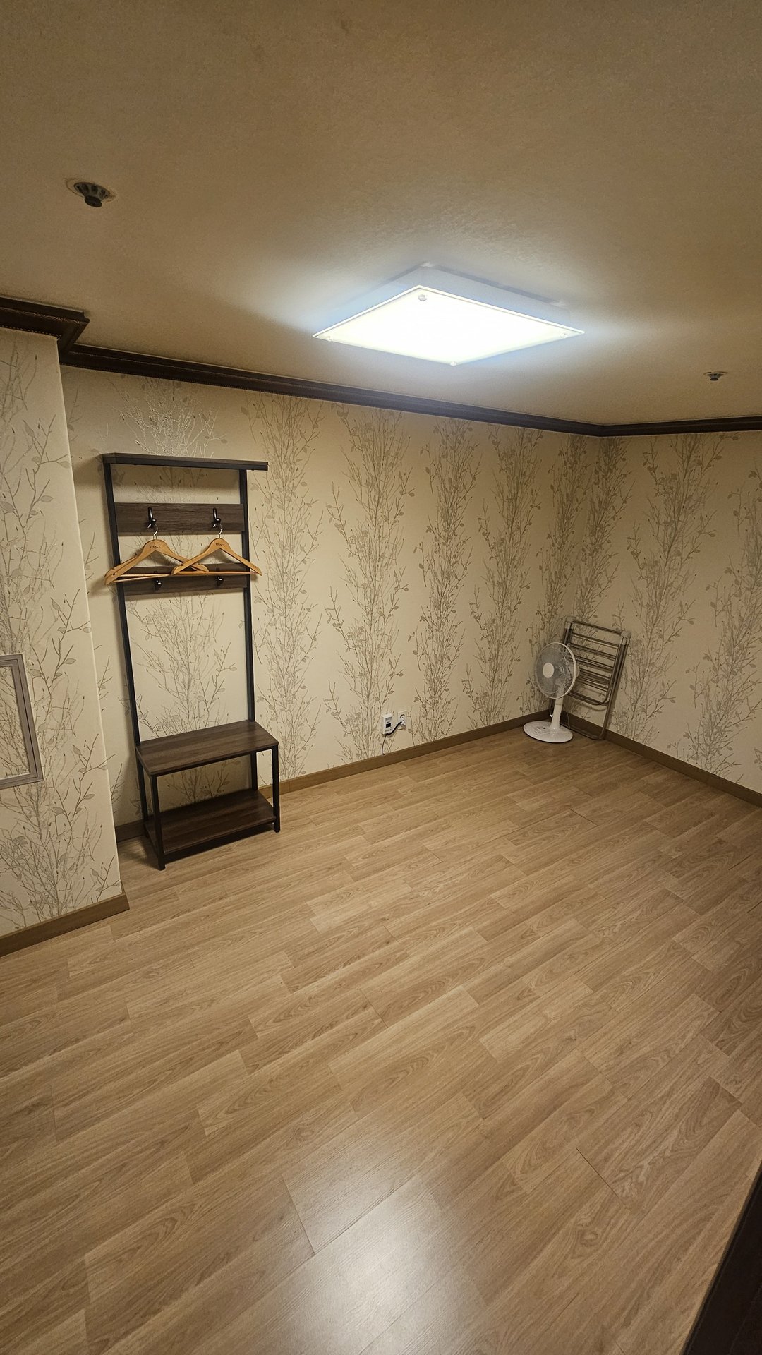 Duplex staircase at Vivace Resort Hadong with branch-pattern wallpaper and clothes hanger