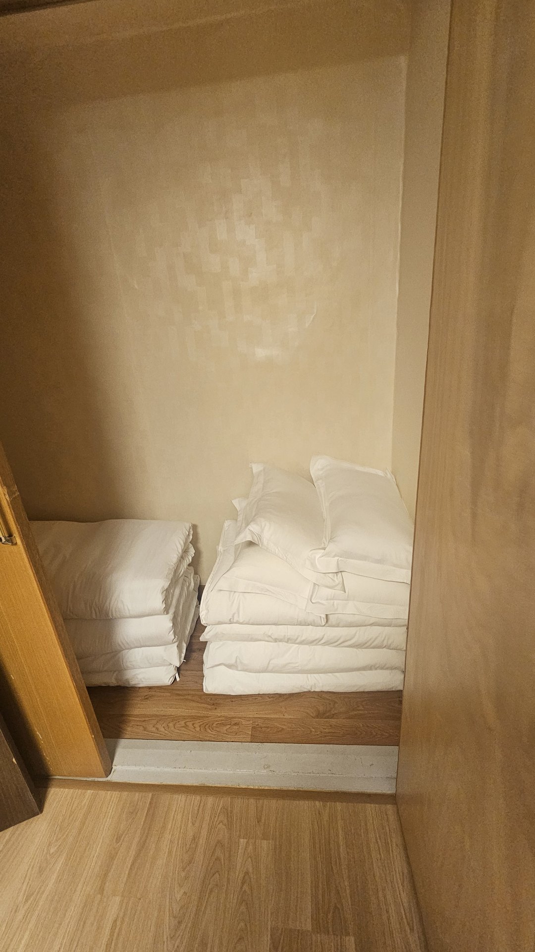Close-up of neatly made double bed with white pillows and duvet in Vivace Resort Royal Suite