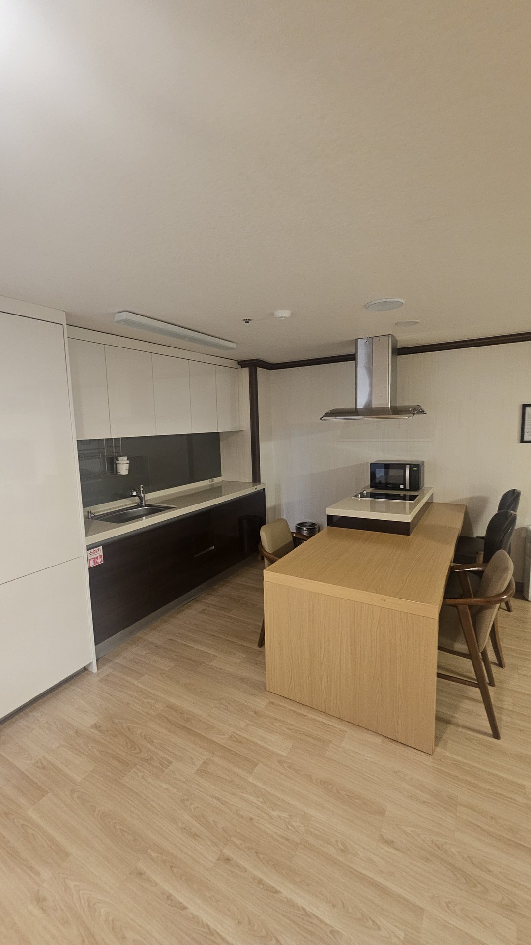 Kitchen and dining area in Vivace Resort Royal Suite with sink, microwave, and dining table