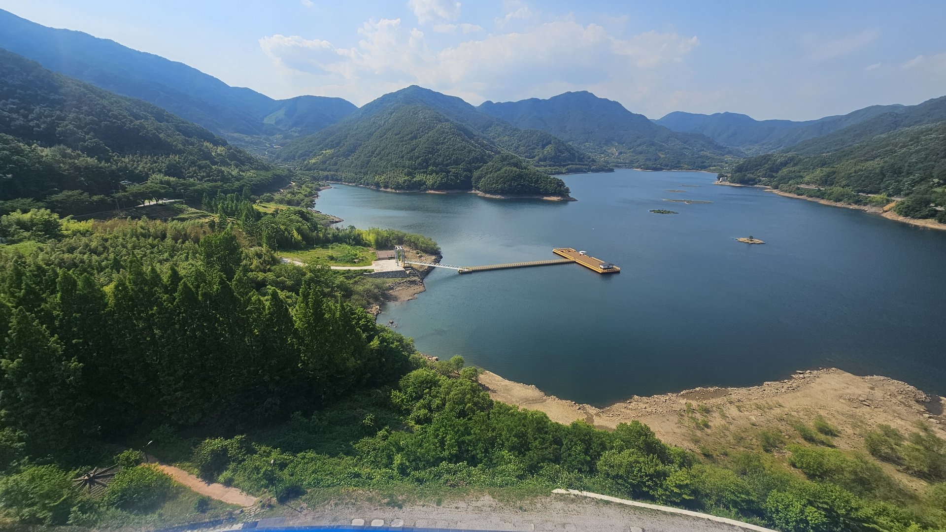 River and mountain view from Vivace Resort Royal Suite window showing floating dock and green hills