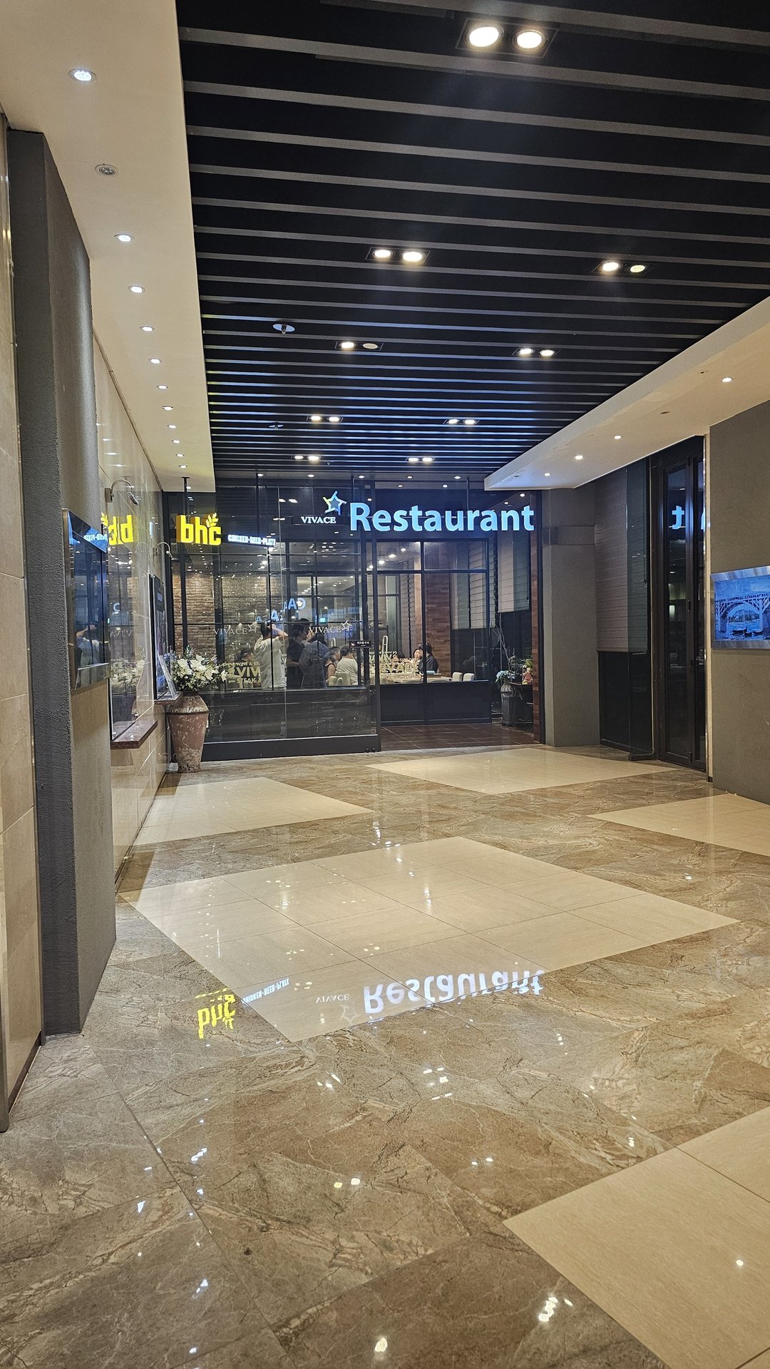 VIVACE Restaurant entrance at Vivace Resort Hadong at night with marble lobby and glass facade