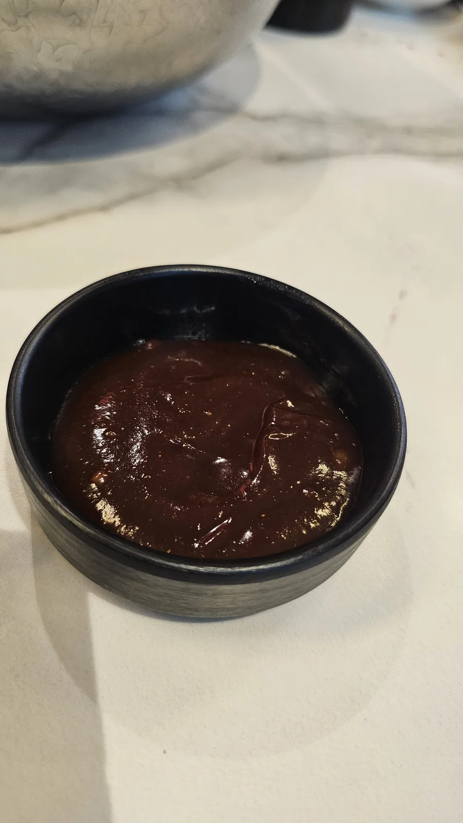 Dark hoisin sauce (tiamianjiang) in small bowl close-up for Peking duck at Xin Hong Lou Yeouido