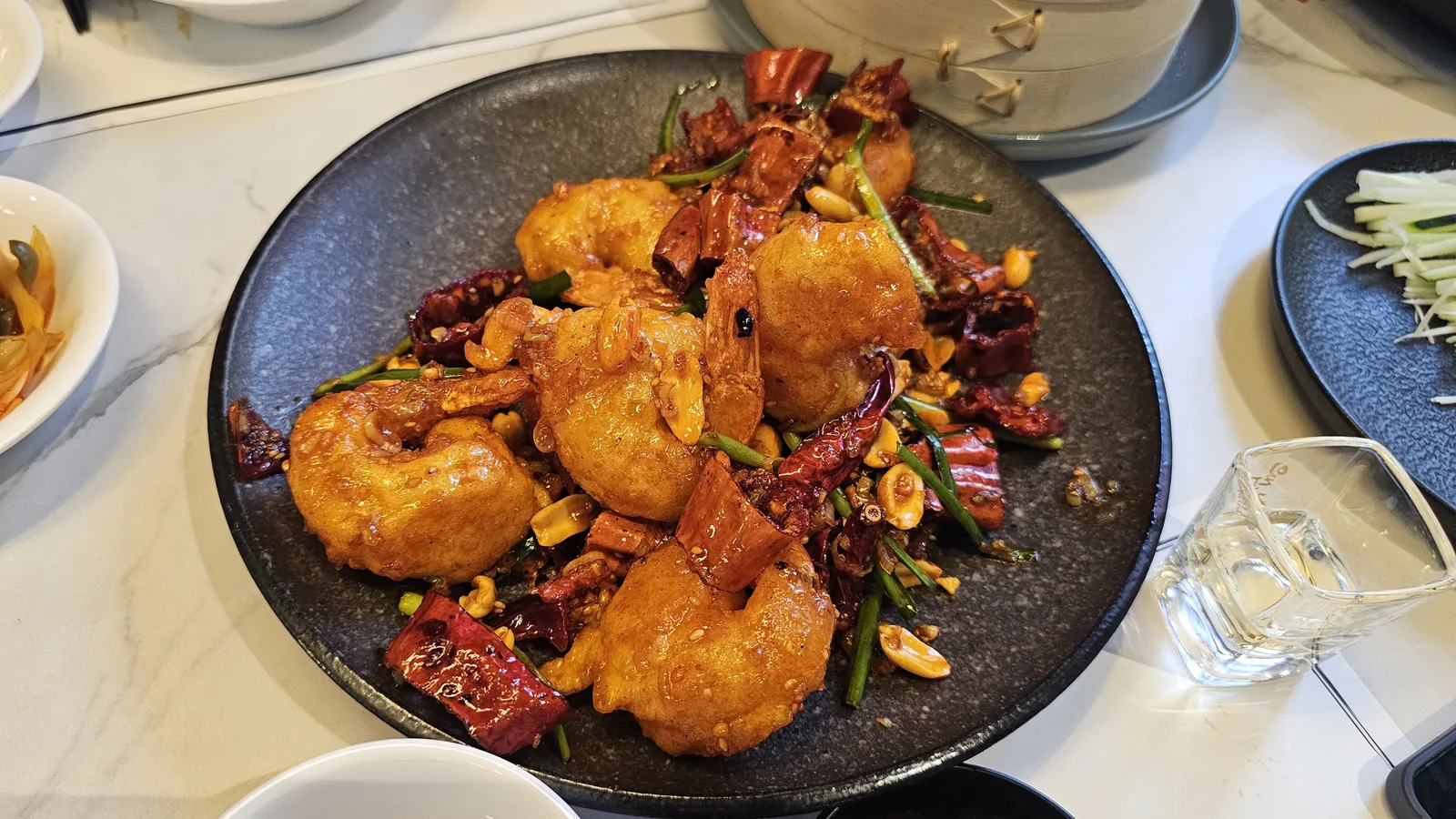 Spicy stir-fried shrimp with dried red chilies peanuts and scallions at Xin Hong Lou