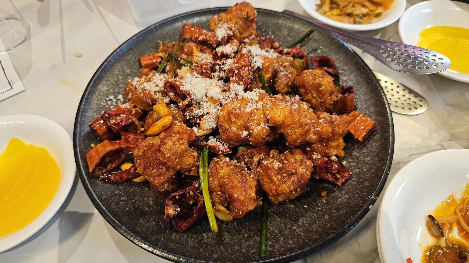 Crispy fried chicken with dried chilies peanuts and seasoning powder at Xin Hong Lou