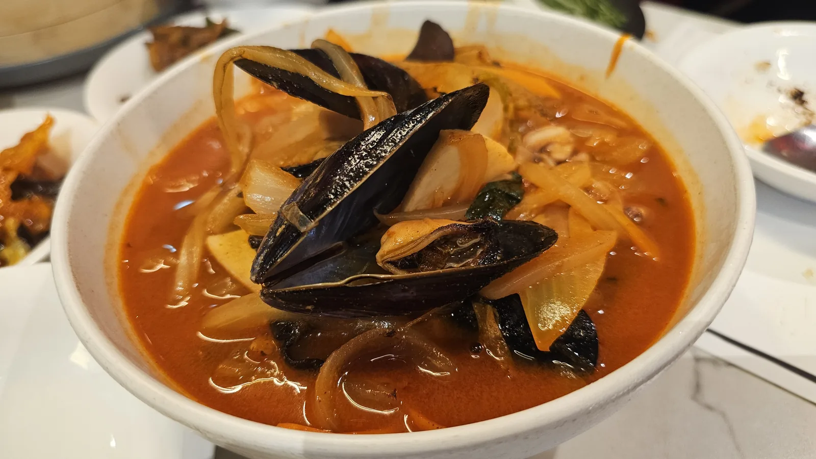 Spicy red jjamppong noodle soup with mussels close-up at Xin Hong Lou Yeouido