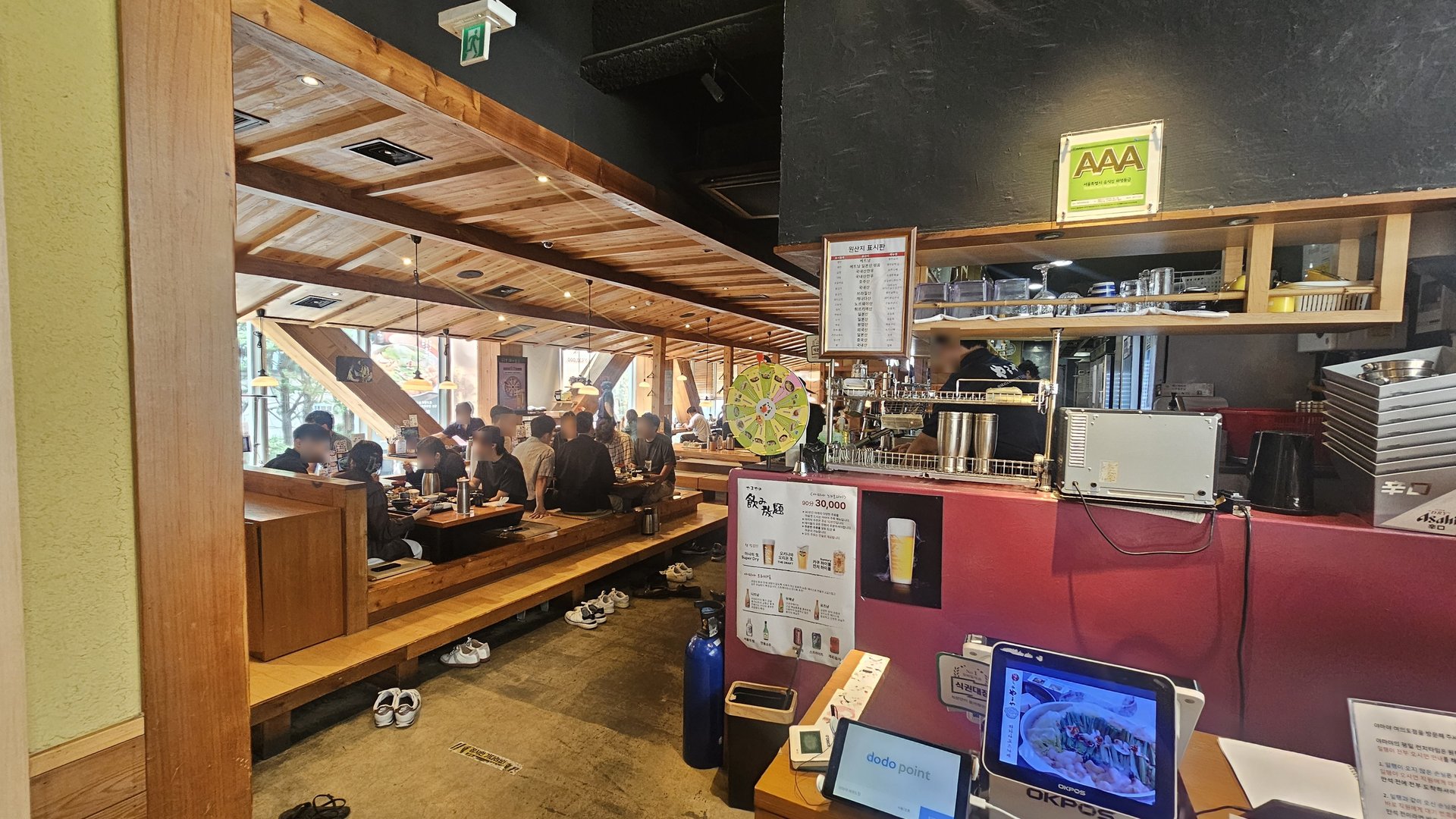 Yamaya Yeouido interior during lunch rush — wide wooden hall with floor seating and table seating packed with diners