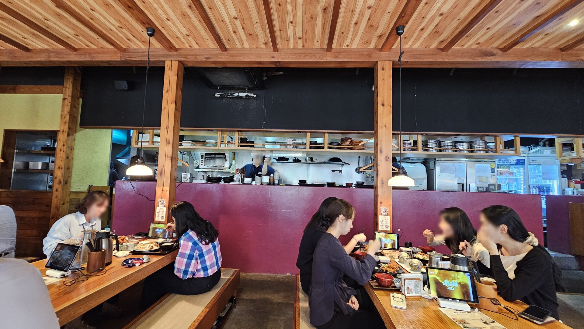 Yamaya Yeouido dining hall with customers eating lunch, open kitchen visible in background with staff cooking