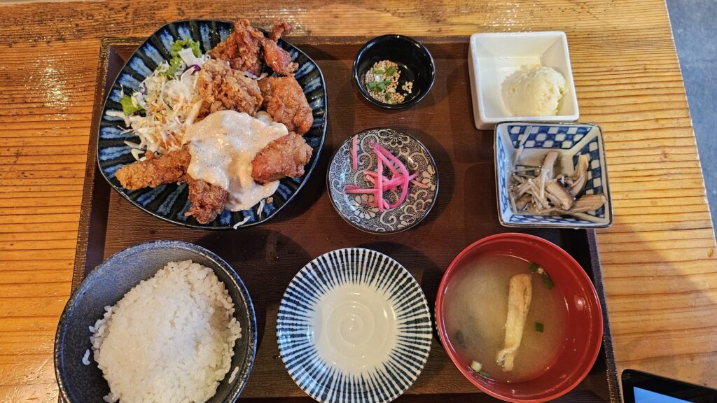 Top-down view of Yamaya lunch set showing fried chicken main, rice, miso soup, mushroom side, and tofu